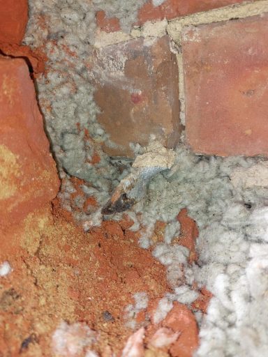 The remains of a rusted wall tie